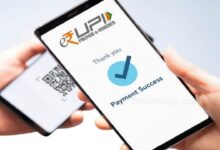 A Person Holding Phone Showing UPI Scan with New UPI Rules