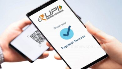 A Person Holding Phone Showing UPI Scan with New UPI Rules